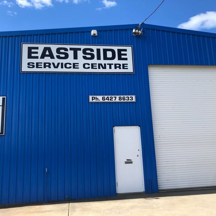 The Eastside Service Centre sign on the blue workshop cladding, with the phone number below it